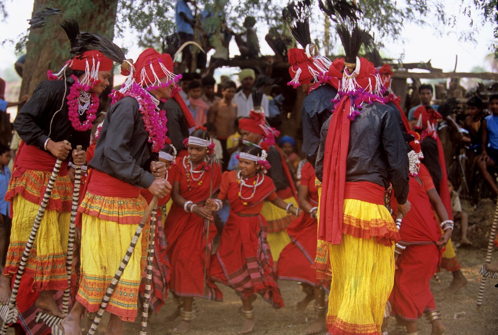 Artisan hand carving complex spiritual motifs on traditional Bastar wooden artifacts